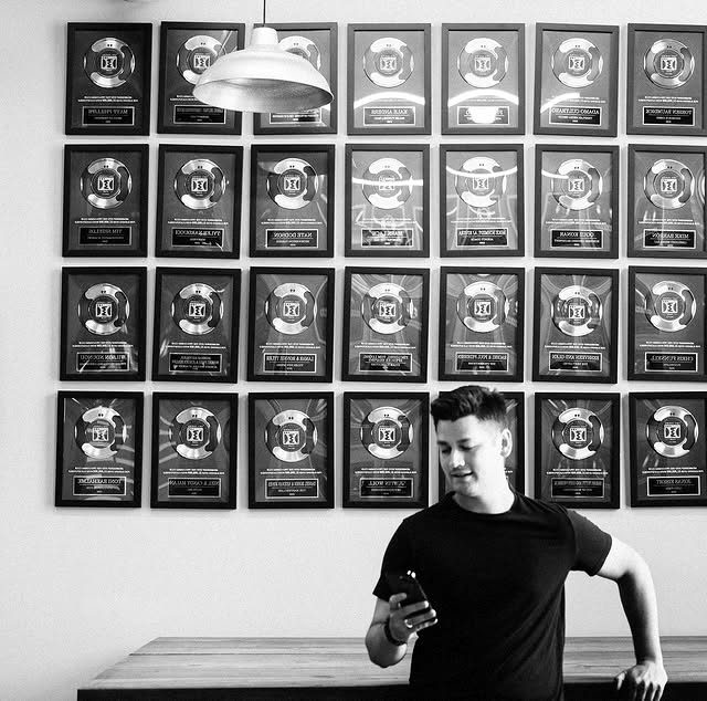 Jimmy in front of a wall of funnel-building awards